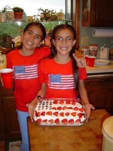 Fran and Amanda, now all grown up, with the cake they made!